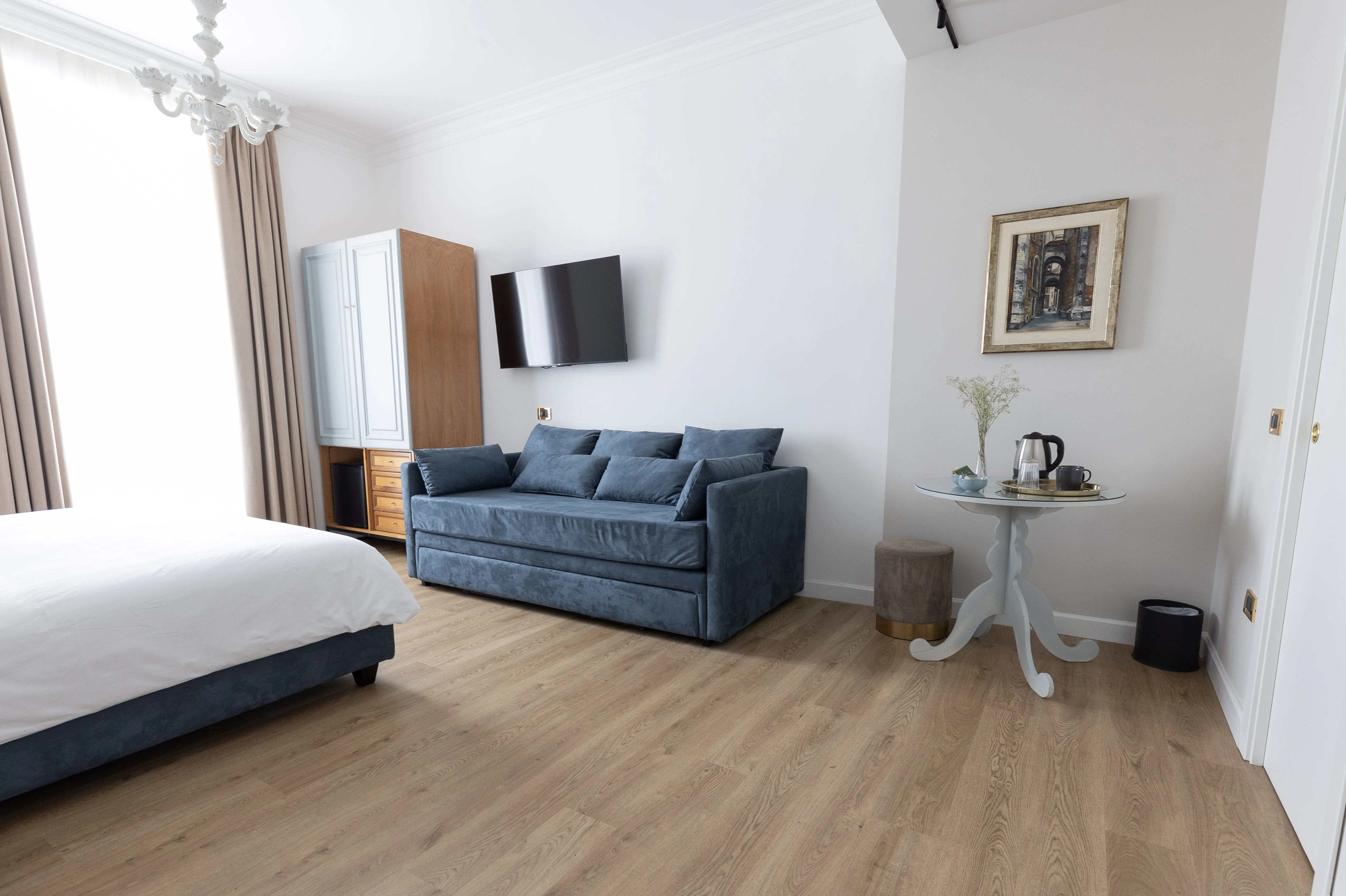 Camera King Suite - Tripla — vista panoramica con divano letto, armadio e lampadario veneziano
